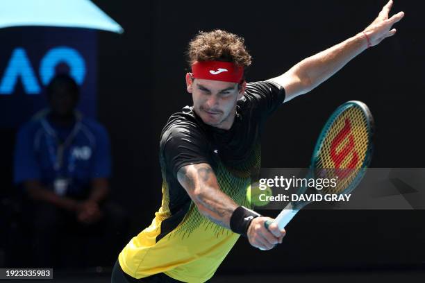 Brazil's Thiago Seyboth Wild hits a return against Russia's Andrey Rublev during their men's singles match on day one of the Australian Open tennis...