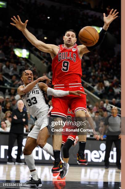 Tre Jones of the San Antonio Spurs passes by Nikola Vucevic of the Chicago Bulls in the second half at Frost Bank Center on January 13, 2024 in San...