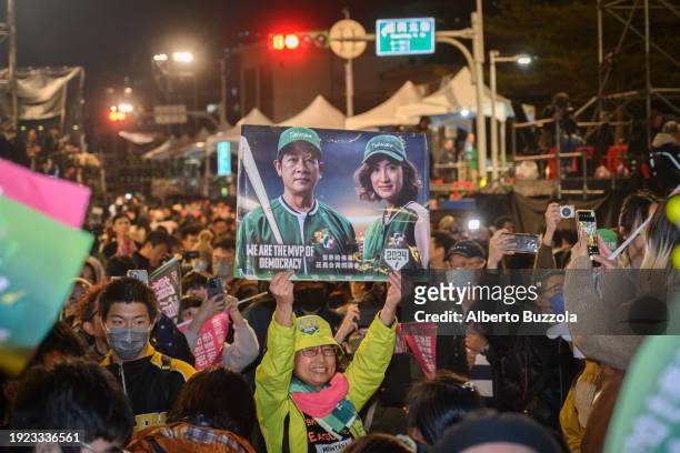 Woman holding a cardboard sign depicting the images of president and Vice President elected Lai Ching-teh and Hsiao Bi-khim at the Democratic...