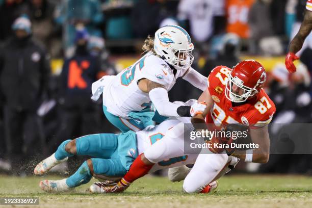 Travis Kelce of the Kansas City Chiefs is tackled after a catch during an NFL Super Wild Card Weekend playoff game against the Miami Dolphins at GEHA...