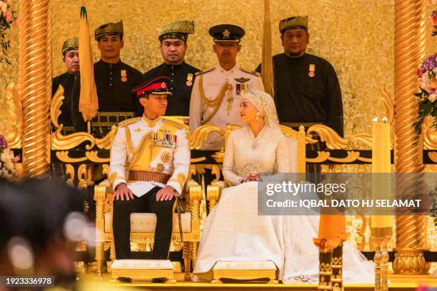 Prince Abdul Mateen and Yang Mulia Anisha Rosnah sit during their wedding reception at Istana Nurul Iman in Brunei's capital Bandar Seri Begawan on...