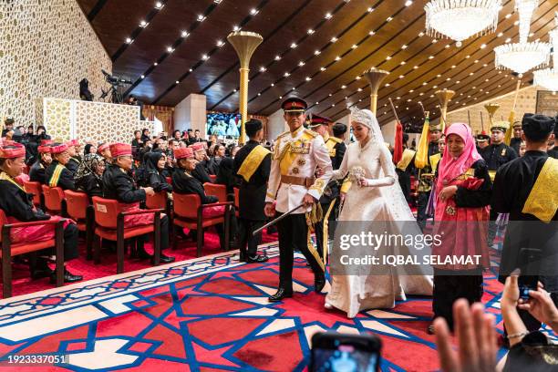 Prince Abdul Mateen and Yang Mulia Anisha Rosnah walk down the aisle during their wedding reception at Istana Nurul Iman in Brunei's capital Bandar...