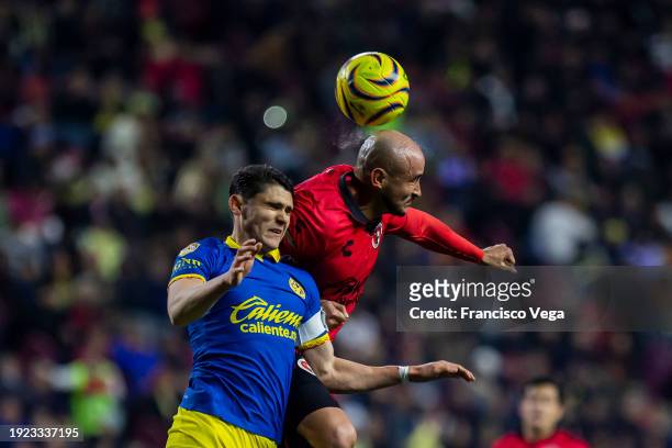 Israel Reyes of America fights for the ball with Carlos Gonzalez of Tijuana during the 1st round match between Tijuana and America as part of the...