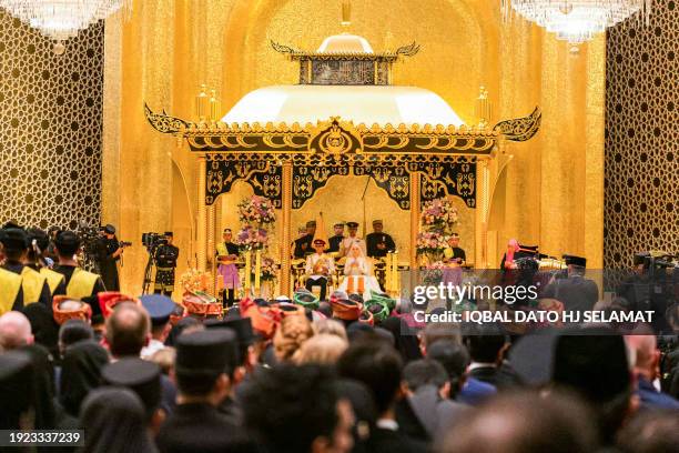 Prince Abdul Mateen and Yang Mulia Anisha Rosnah sit during their wedding reception at Istana Nurul Iman in Brunei's capital Bandar Seri Begawan on...