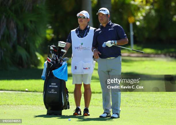 Hideki Matsuyama of Japan converses with his caddie Shota Hayafuji on the 10th hole during a pro-am prior to the Sony Open in Hawaii at Waialae...