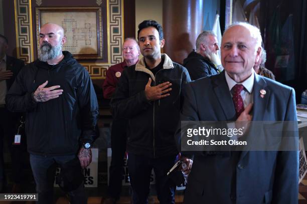 Republican presidential candidate businessman Vivek Ramaswamy stands alongside former Iowa Congressman Steve King as they listen to the national...