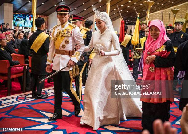 Prince Abdul Mateen and Yang Mulia Anisha Rosnah walk down the aisle during their wedding reception at Istana Nurul Iman in Brunei's capital Bandar...