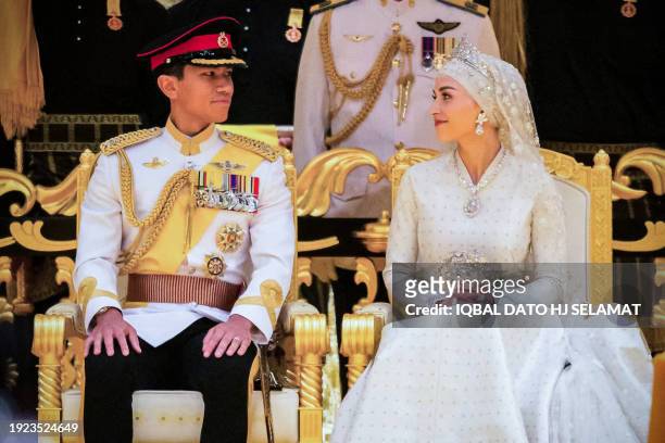 Prince Abdul Mateen and Yang Mulia Anisha Rosnah sit during their wedding reception at Istana Nurul Iman in Brunei's capital Bandar Seri Begawan on...