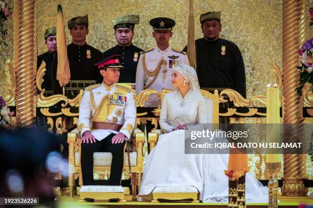 Prince Abdul Mateen and Yang Mulia Anisha Rosnah sit during their wedding reception at Istana Nurul Iman in Brunei's capital Bandar Seri Begawan on...