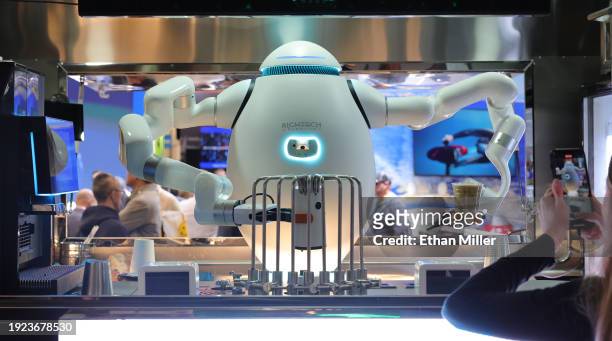 An interactive robot bartender, barista and chef, makes drinks for attendees at the Richtech Robotics booth during CES 2024 at the Las Vegas...