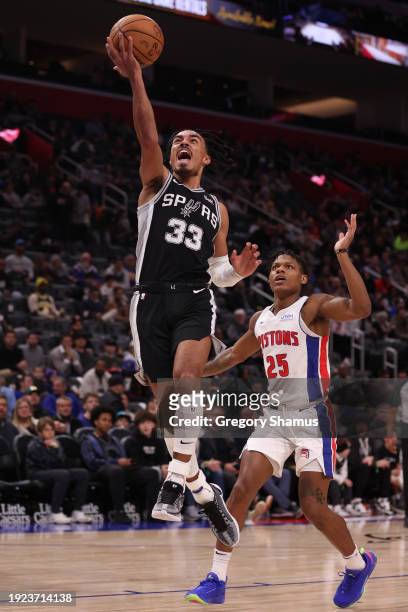 Tre Jones of the San Antonio Spurs drives to the basket past Marcus Sasser of the Detroit Pistons during the second half at Little Caesars Arena on...