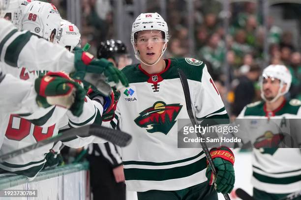 Matt Boldy of the Minnesota Wild celebrates scoring a goal with the bench during the third period against the Dallas Stars at American Airlines...