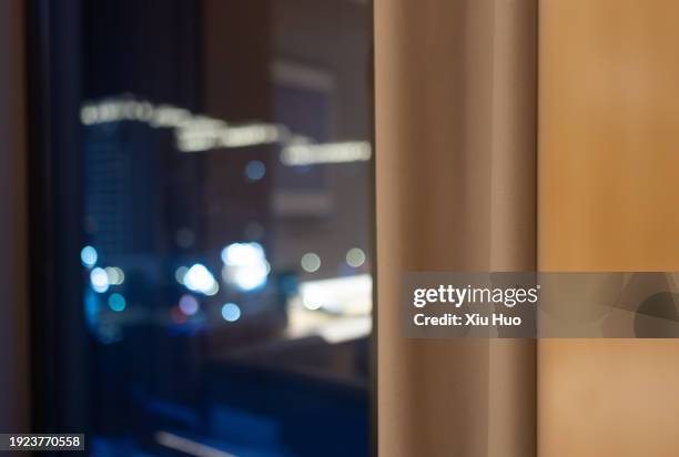 close-up of indoor curtains and outdoor night view at night - close-curtains stockfoto's en -beelden