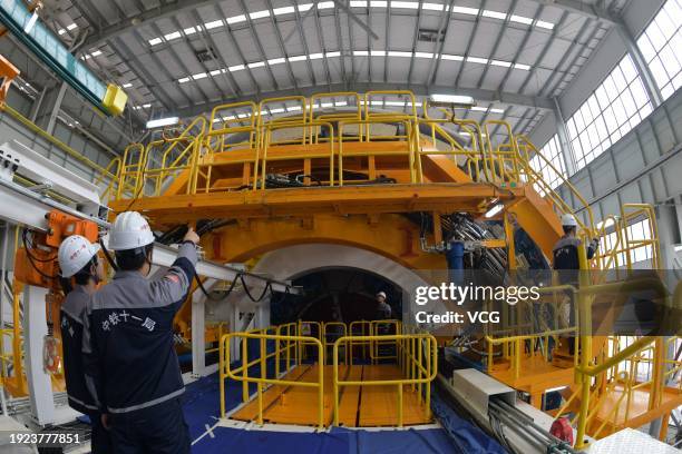 Technical workers of China Railway Construction Heavy Industry Corporation Limited work on the tunnel boring machine Dinghai at an industrial park on...