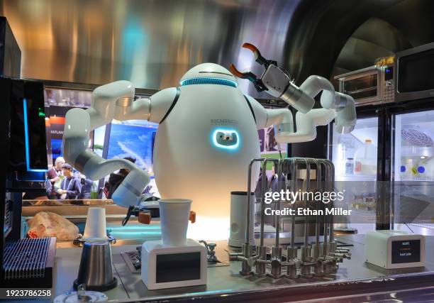 An interactive robot bartender, barista and chef, makes drinks for attendees at the Richtech Robotics booth during CES 2024 at the Las Vegas...