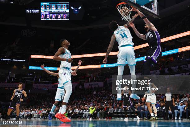 Domantas Sabonis of the Sacramento Kings dunks the ball against Nick Richards of the Charlotte Hornets during the second half of the game at Spectrum...