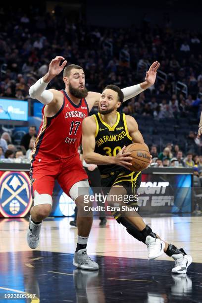 Stephen Curry of the Golden State Warriors is guarded by Jonas Valanciunas of the New Orleans Pelicans in the second half at Chase Center on January...