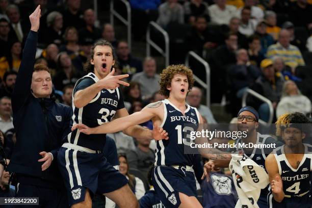 Boden Kapke and Finley Bizjack of the Butler Bulldogs celebrate after a basket in the second half against the Marquette Golden Eagles at Fiserv Forum...