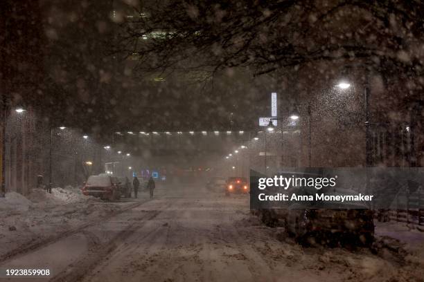 People walk in the streets of downtown Des Moines during a snow squall on January 10, 2024 in Des Moines, Iowa. Republican presidential candidates...