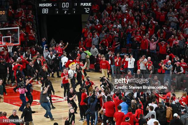 Fans storm court after the win by the Nebraska Cornhuskers over the Purdue Boilermakers at Pinnacle Bank Arena on January 9, 2024 in Lincoln,...