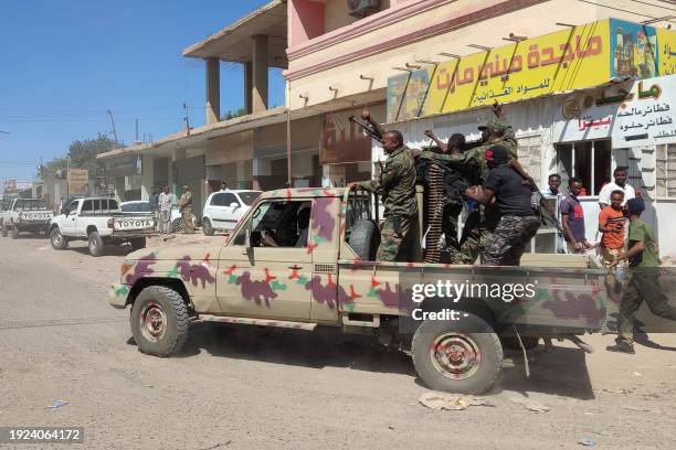 Sudanese soldiers and enroled personnel drive a pick up truck mounted with a machine gun on a street in Gedaref city, Sudan, on January 14, 2024 amid...