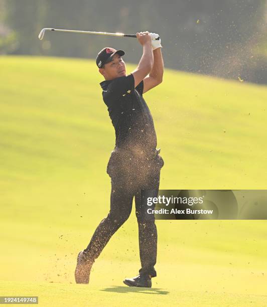 Ashun Wu of China plays his third shot on the fourth hole on Day One of the Dubai Invitational at Dubai Creek Golf and Yacht Club on January 11, 2024...