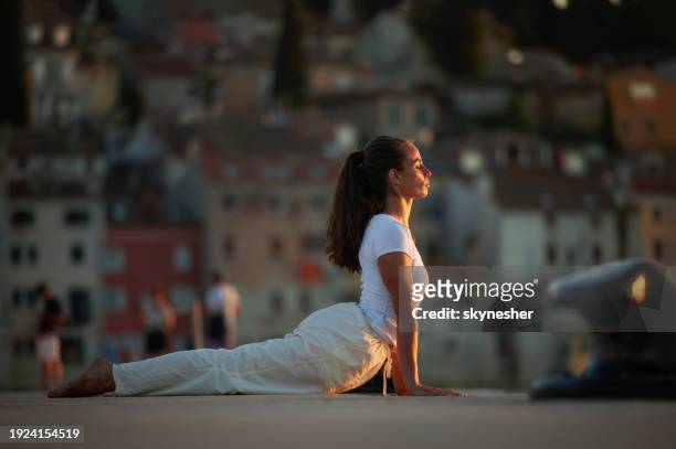 yoga stretching exercises on a pier! - rovinj stock pictures, royalty-free photos & images