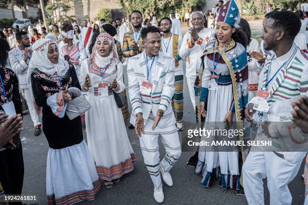 Couples dressed in a traditional attire dance during a mass wedding called 'Yeshih Gabicha' in Addis Ababa, Ethiopia on January 14, 2024. Hundreds of...
