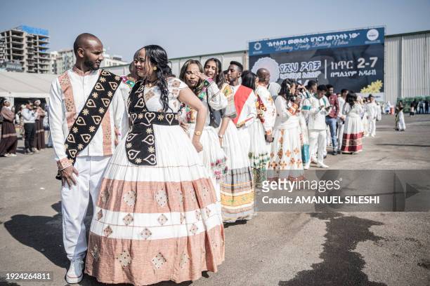 Couples dressed in a traditional attire line up during a mass wedding called 'Yeshih Gabicha' in Addis Ababa, Ethiopia on January 14, 2024. Hundreds...