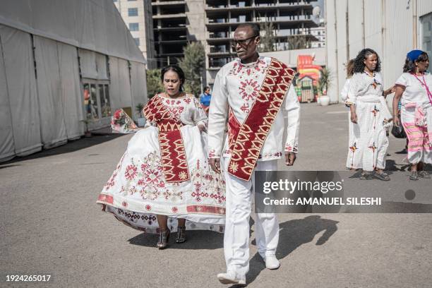 Couples dressed in a traditional attire walk during a mass wedding called 'Yeshih Gabicha' in Addis Ababa, Ethiopia on January 14, 2024. Hundreds of...