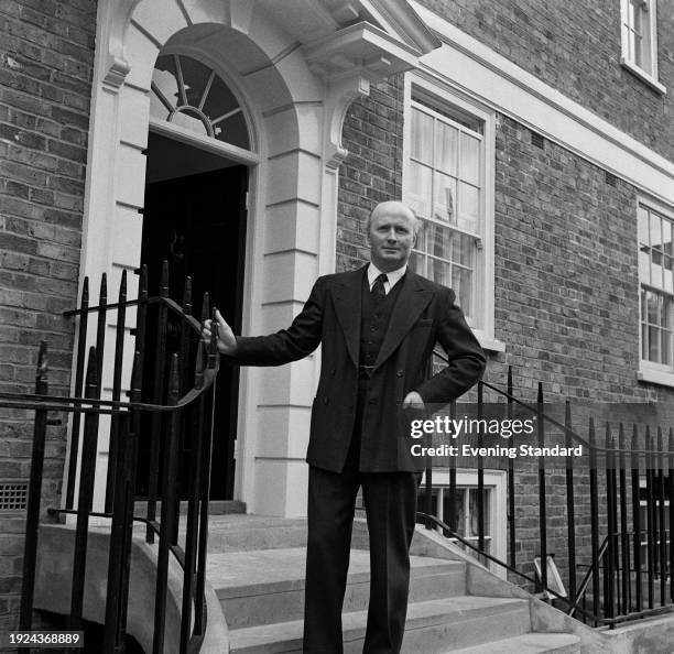 Edward Astley, 22nd Baron Hastings , posing outside a residential building, June 4th 1957.