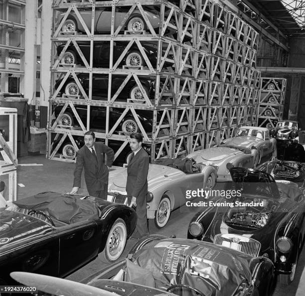 Two men inspect cars being prepared for export at the Morris Motors factory in Cowley, Oxfordshire, May 8th 1957.
