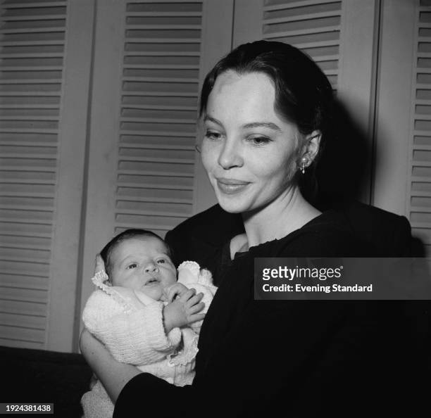 French actress Leslie Caron holding her baby son Christopher, April 15th 1957.