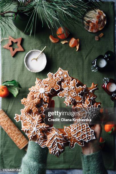 woman holding christmas gingerbread cookies wreath - yule marble stock pictures, royalty-free photos & images