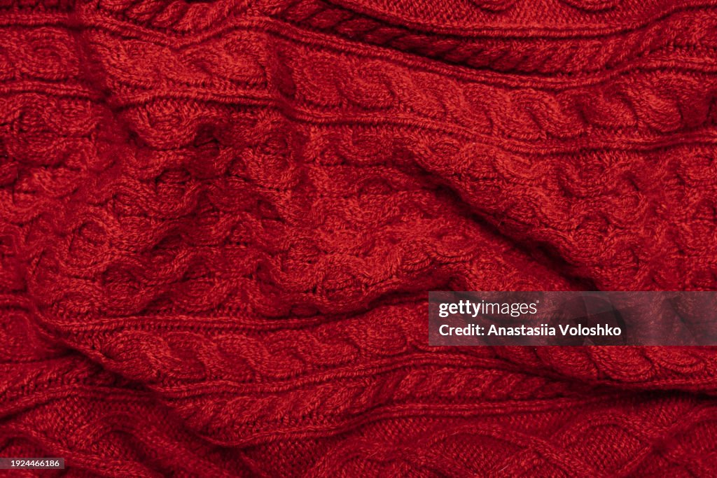 Texture of a knitted red Christmas sweater. Perfect background