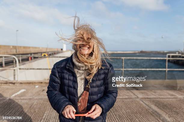 windy hair - older woman colored hair stock pictures, royalty-free photos & images