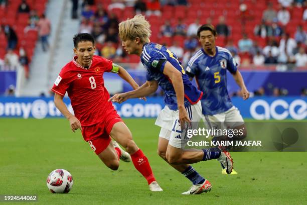 Vietnam's midfielder Do Hung Dung fights for the ball with Japan's midfielder Keito Nakamura during the Qatar 2023 AFC Asian Cup Group D football...