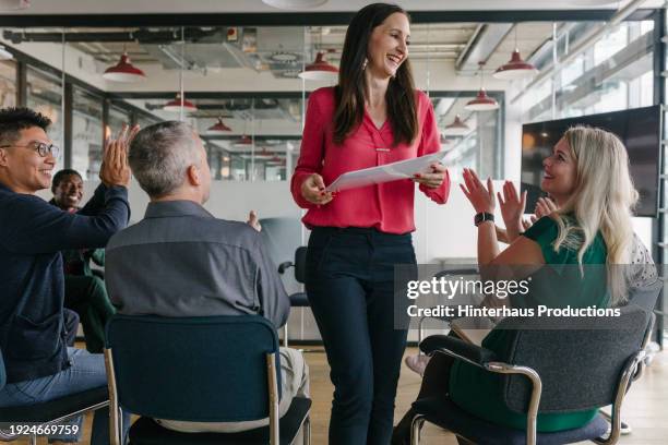 employees applauding colleague after business presentation - mature man smiling 40 44 years blond hair stock pictures, royalty-free photos & images