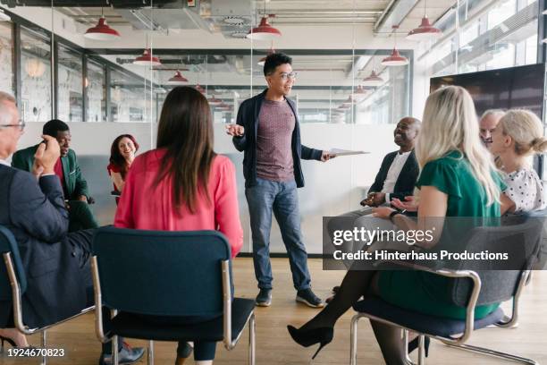 confident office employee giving presentation in seminar room - mature man smiling 40 44 years blond hair stock pictures, royalty-free photos & images