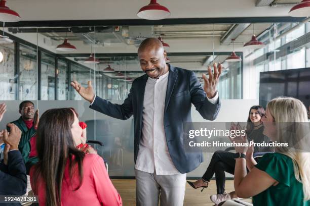 business associate with arms in air receiving applause from seminar group - applauding stock pictures, royalty-free photos & images