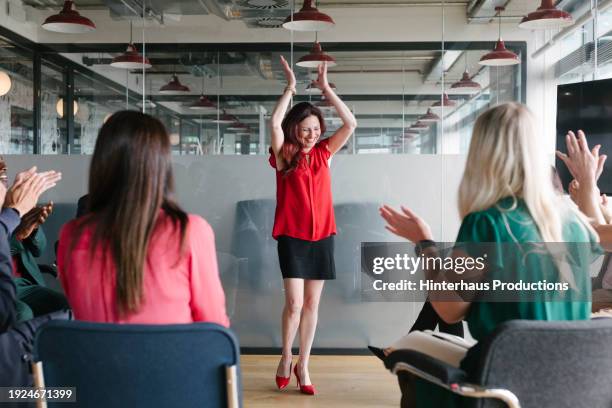 businesswoman receiving applause after office presentation - applauding stock pictures, royalty-free photos & images