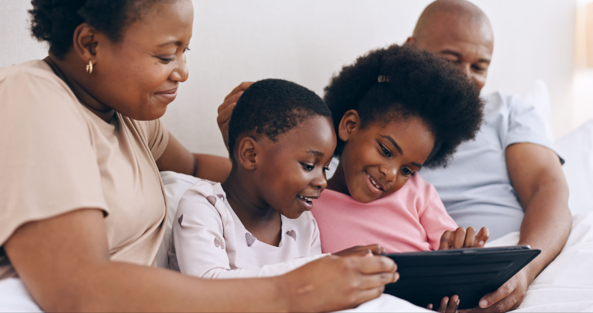 Children, parents and tablet in bedroom for online games, download multimedia and reading ebook. Mom, dad and black family of happy girl kids streaming digital movies, cartoon or subscription at home Children, parents and tablet in bedroom for online games, download multimedia and reading ebook. Mom, dad and black family of happy girl kids streaming digital movies, cartoon or subscription at home