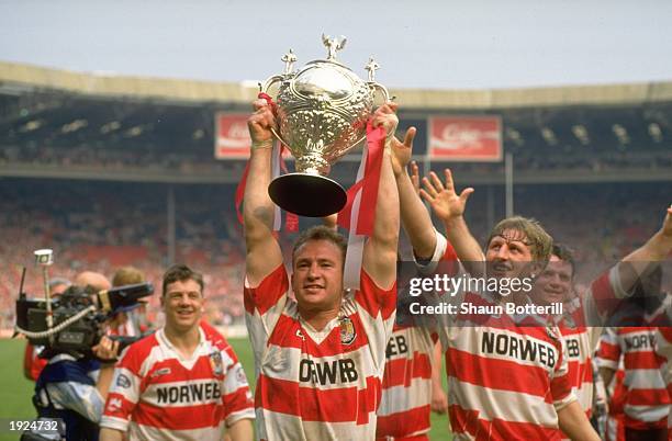 Wigan Captain Dean Bell holds the trophy aloft after the Challenge Cup final against Widnes at Wembley Stadium in London. \ Mandatory Credit: Shaun...