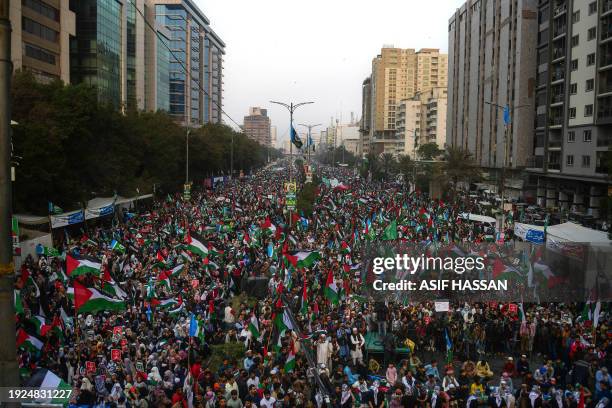 Supporters of Jamaat e Islami display placards and Palestine's flags during a pro-Palestinian march in Karachi on January 14, 2024. Thousands of...