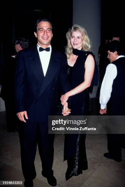 American actor Tony Danza, wearing a tuxedo and bow tie, and his wife, Tracy Danza, who wears a full-length sleeveless black evening gown with a...