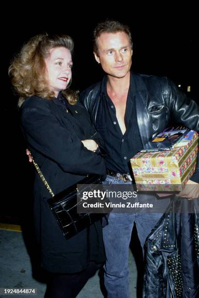 American actress Patti D'Arbanville, wearing a black outfit with a black purse over her right shoulder, and British actor and singer Michael Des...