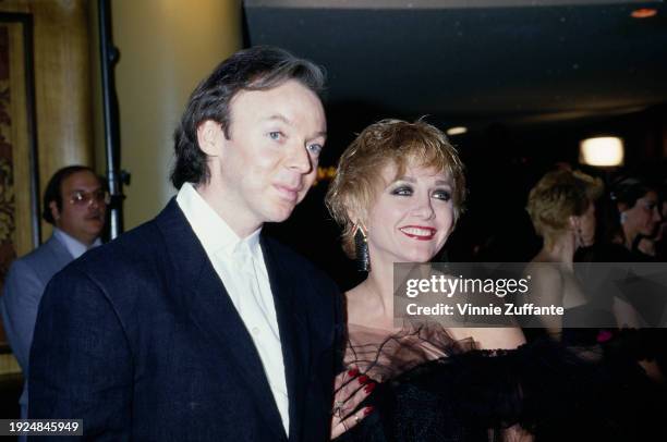 American actor Bud Cort, wearing a black suit with a white shirt, and American actress Patti D'Arbanville, who wears a black off-shoulder outfit,...