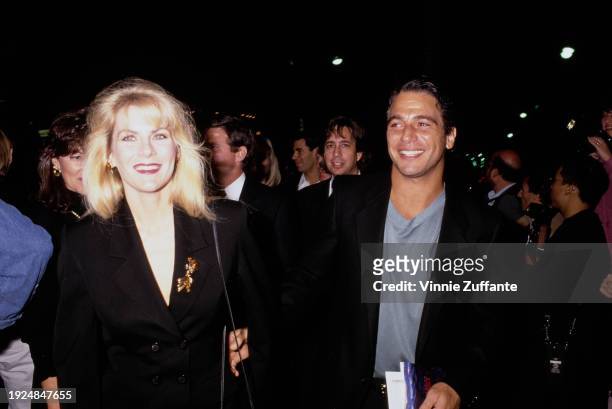 American actor Tony Danza, wearing a black suit over a grey t-shirt, and his wife, Tracy, who wears a black suit with a gold brooch on the lapel,...