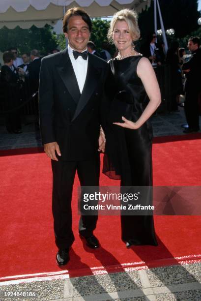 American actor Tony Danza, wearing a tuxedo and bow tie, and his wife, Tracy, who wears a full-length sleeveless black evening gown, attend the 51st...