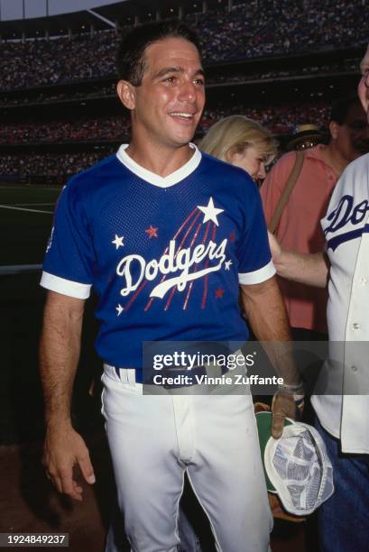 American actor Tony Danza, wearing a Los Angeles Dodgers kit, participates in the Hollywood All-Star Baseball Game, staged at Dodger Stadium, in the...